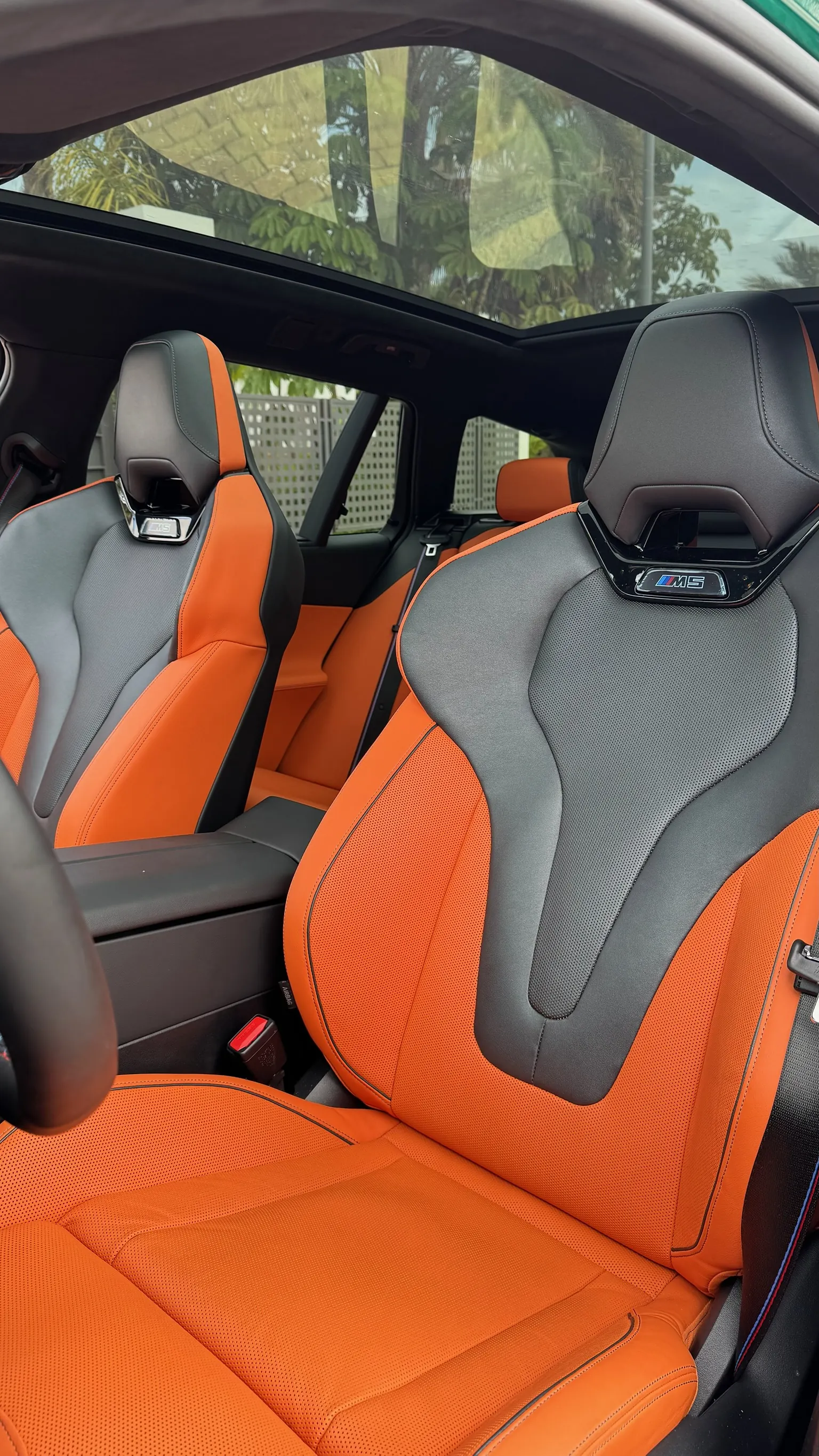 M bucket seats in orange Merino leather and Alcantara with illuminated M5 badge, panoramic glass roof
