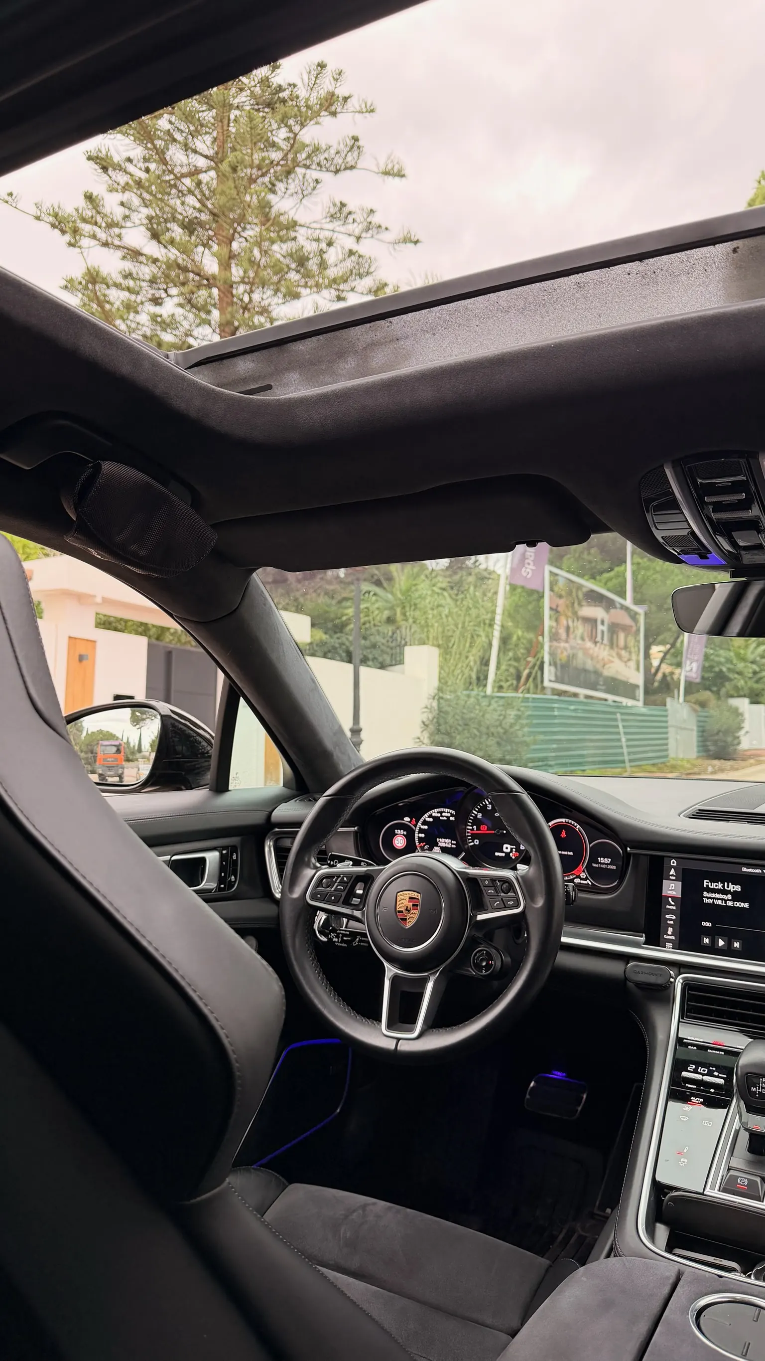 Porsche Panamera GTS cockpit with central analog tachometer, PCM touchscreen and midnight blue ambient lighting